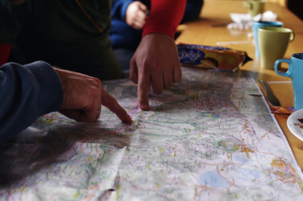 people-pointing-at-map-preparing-for-boating-trip